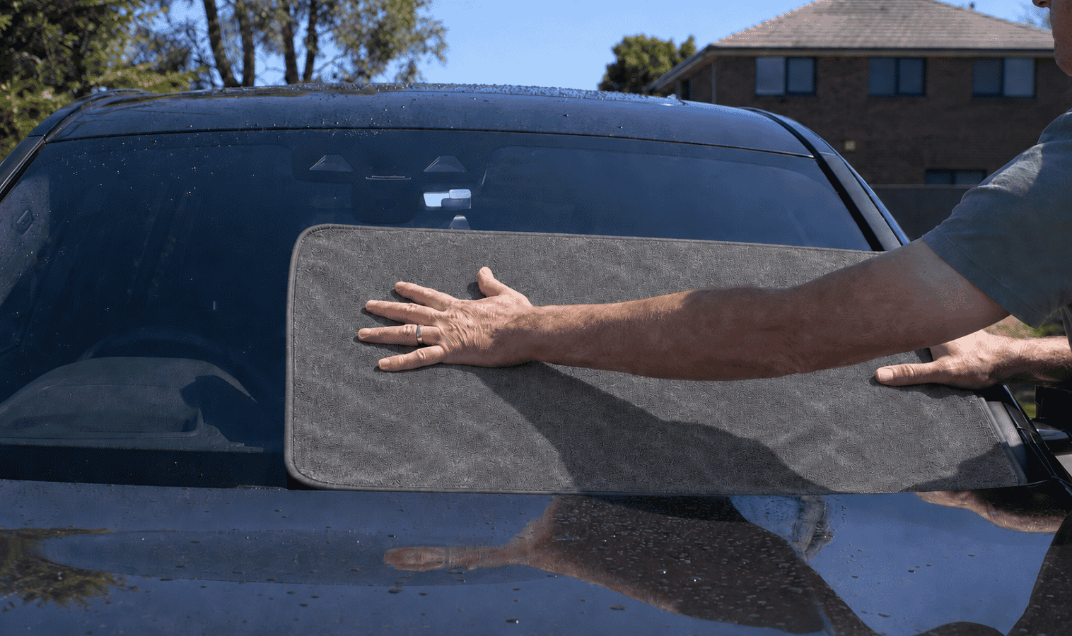 ClothWipe used to clean a car window, showing versatility beyond the bathroom
